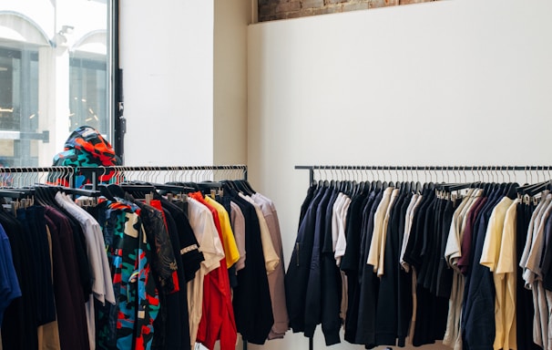 assorted-color clothes hanging on metal racks