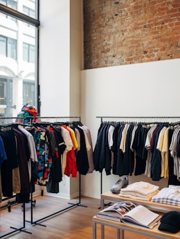 assorted-color clothes hanging on metal racks