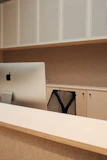 Elegant office desk setup with sleek chair and built-in storage