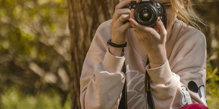 woman taking a photo during daytime