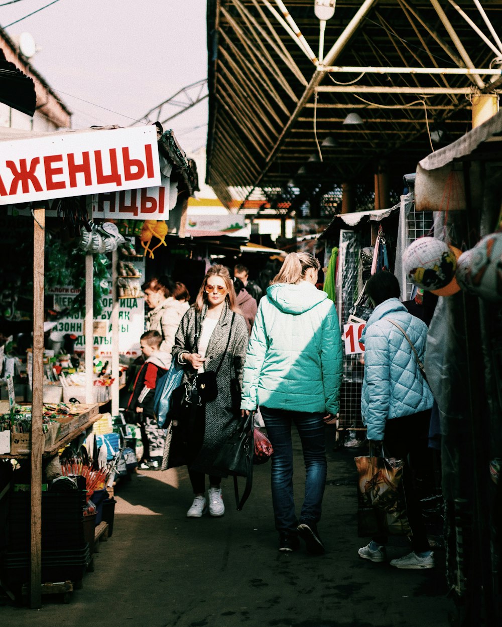 a group of people walking through a market