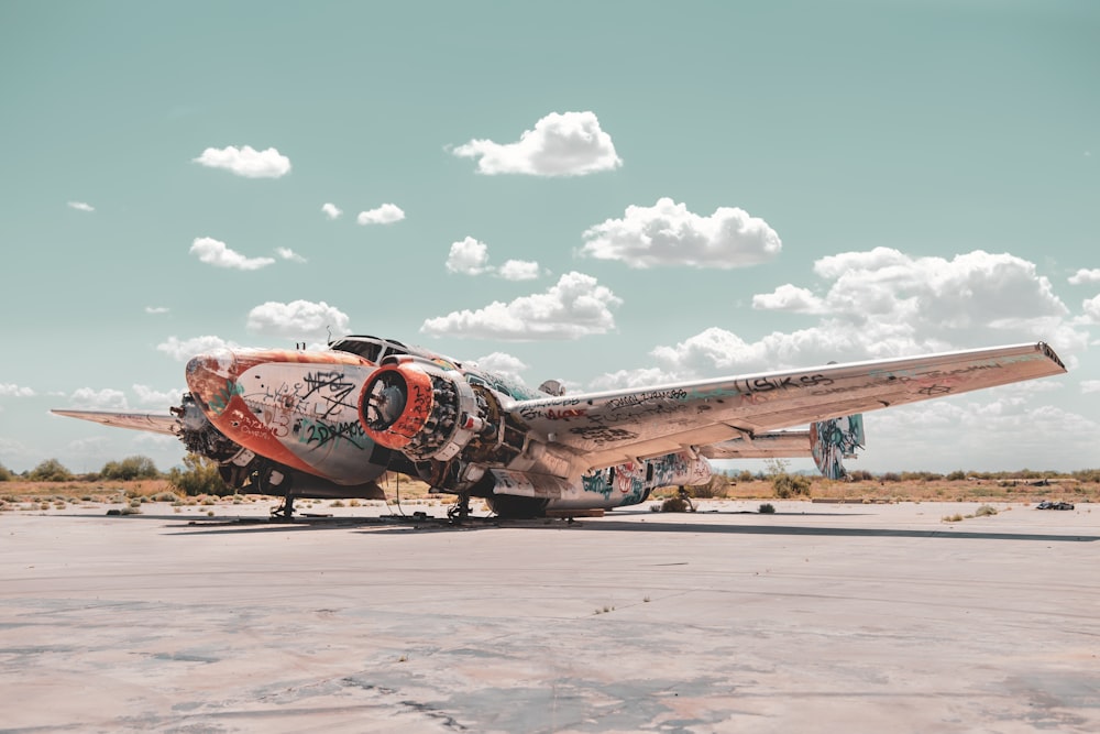 an old airplane with graffiti on the side of it
