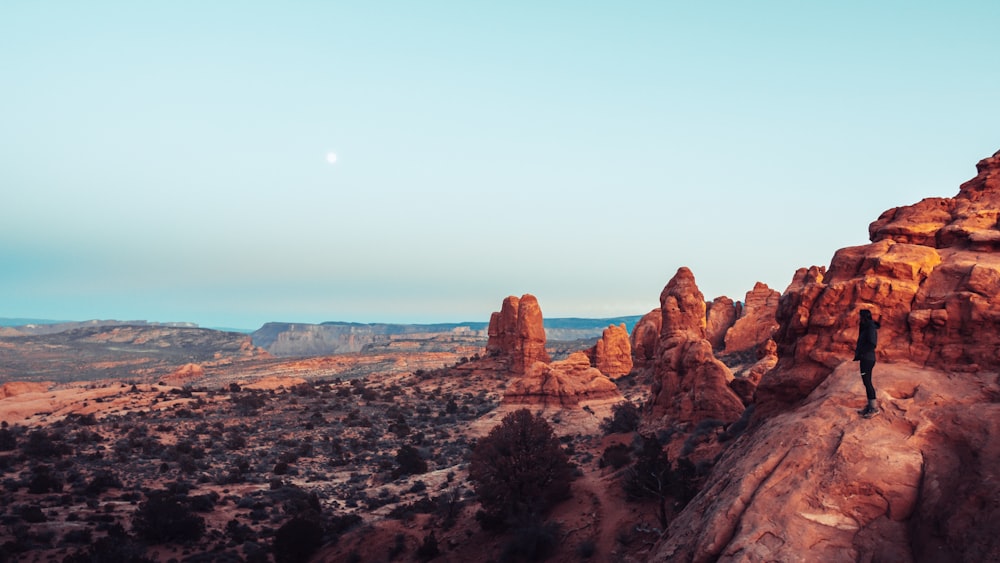 person standing on rock formation