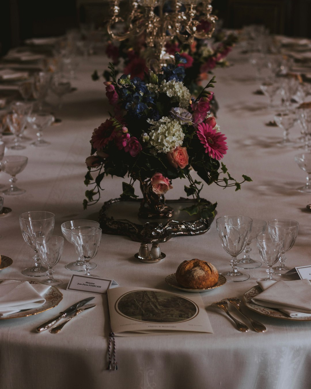 wine glasses on table with flower arrangement