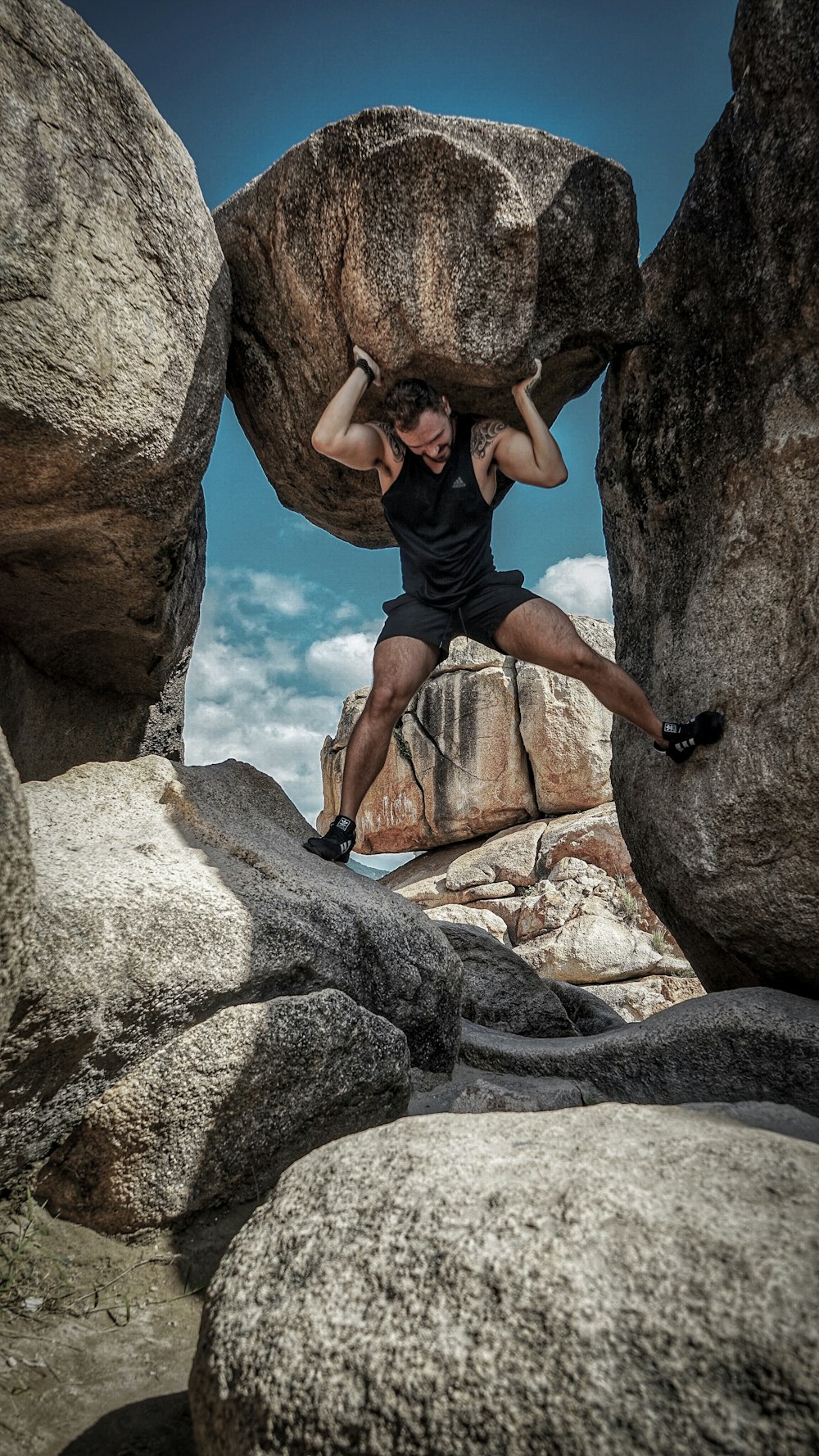 man carrying rock