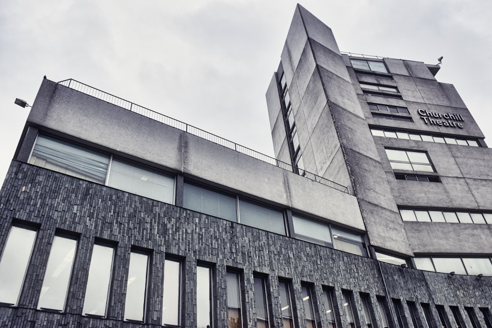 low angle photography of gray concrete building during daytime