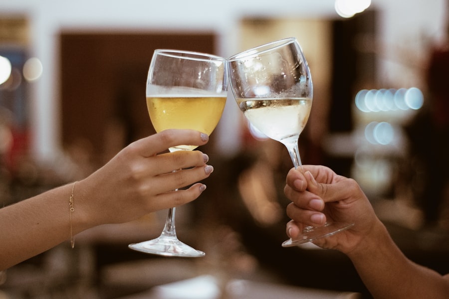 Two hands toasting with glasses of wine