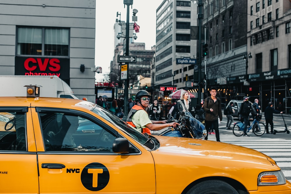 yellow Taxi on road