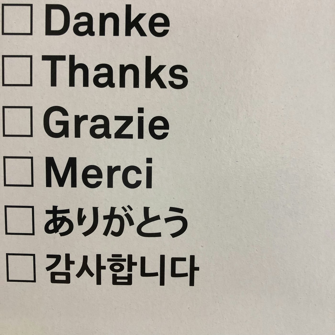 Handwritten note reading "danke, thanks, grazie, merci" — the same word in four languages