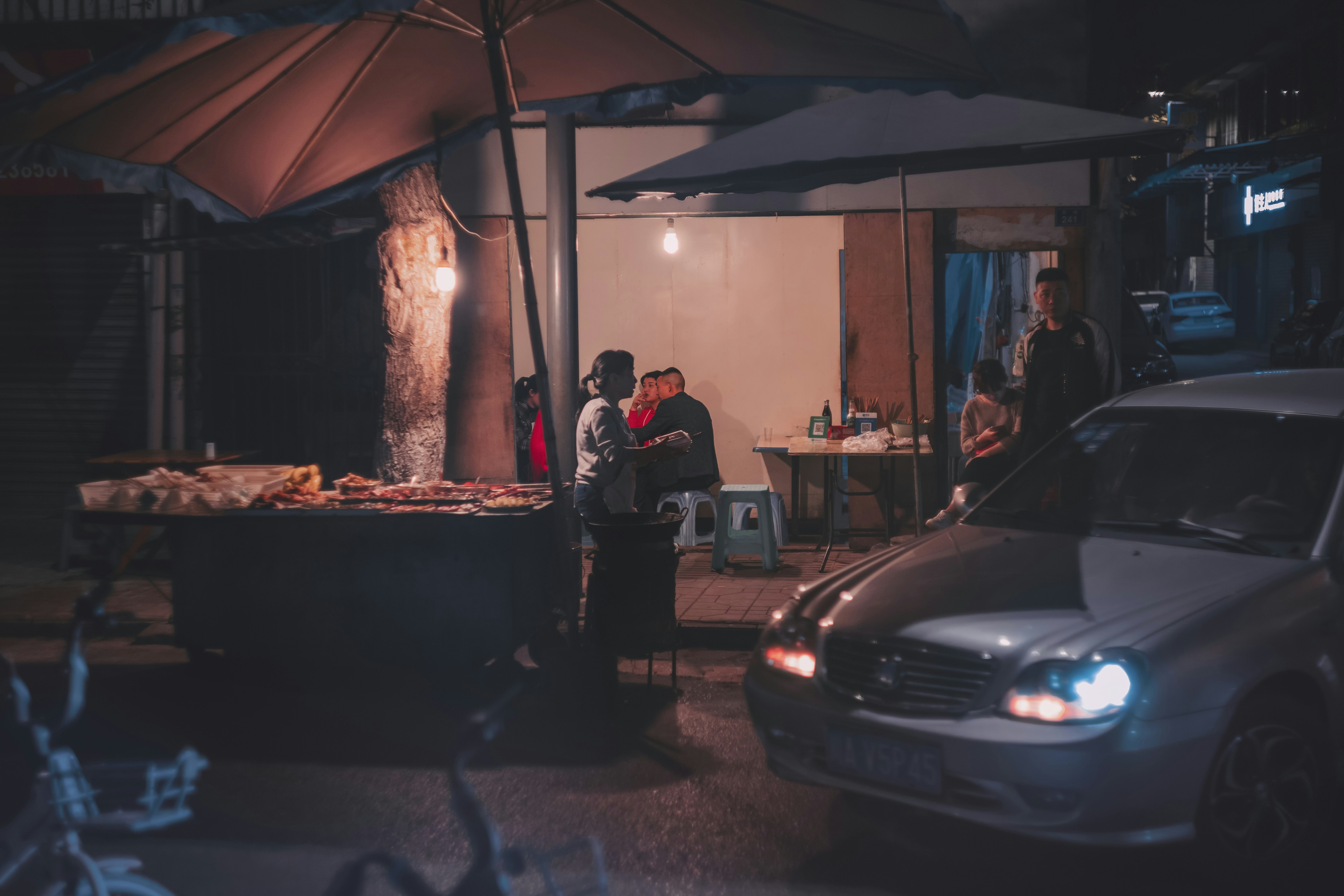 Family plugging an electrical car into a home charging station in a garage