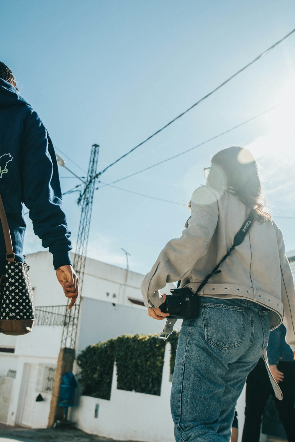 woman walking near white building