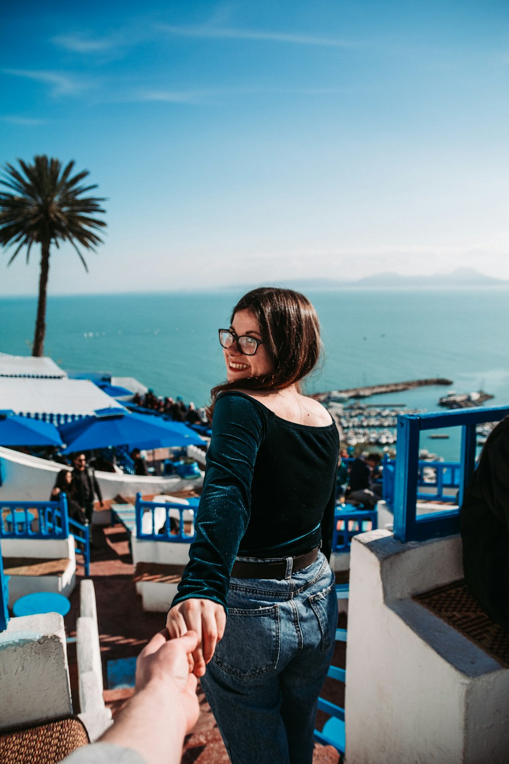 smiling woman holding person's hand