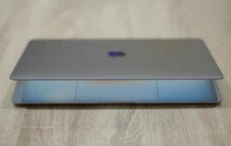 A sleek laptop open on a desk showing a newly installed SSD inside.