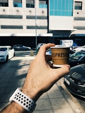 A drone delivering a freshly brewed coffee in an urban setting.