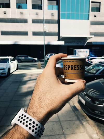 A drone delivering a freshly brewed coffee in an urban setting.
