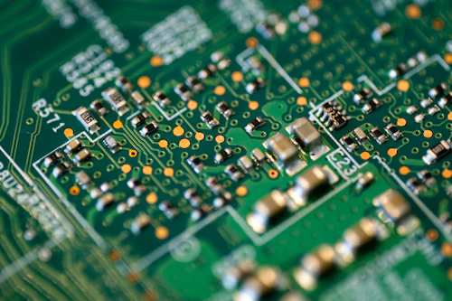 Macro close-up of a circuit board during electronics repair work