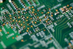 Close-up of electronic circuit boards and components neatly arranged on a workbench.