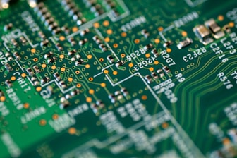 A close-up of a circuit board being assembled.