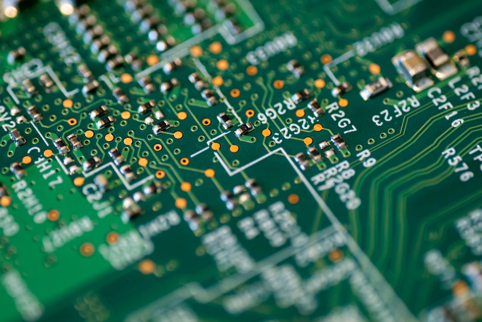 A shallow-focus macro of a green circuit board
