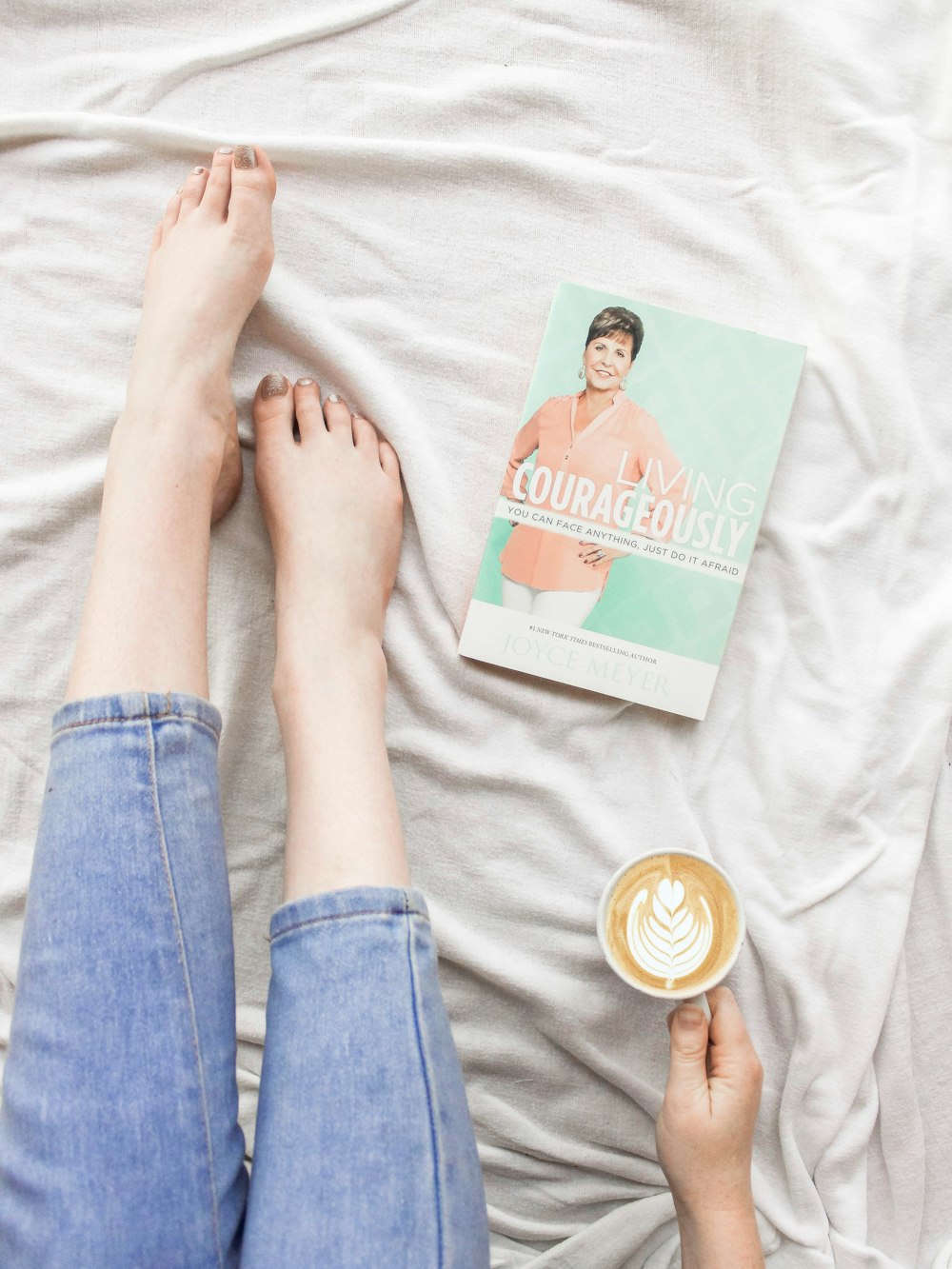 flat lay photography of cup of coffee latte beside book