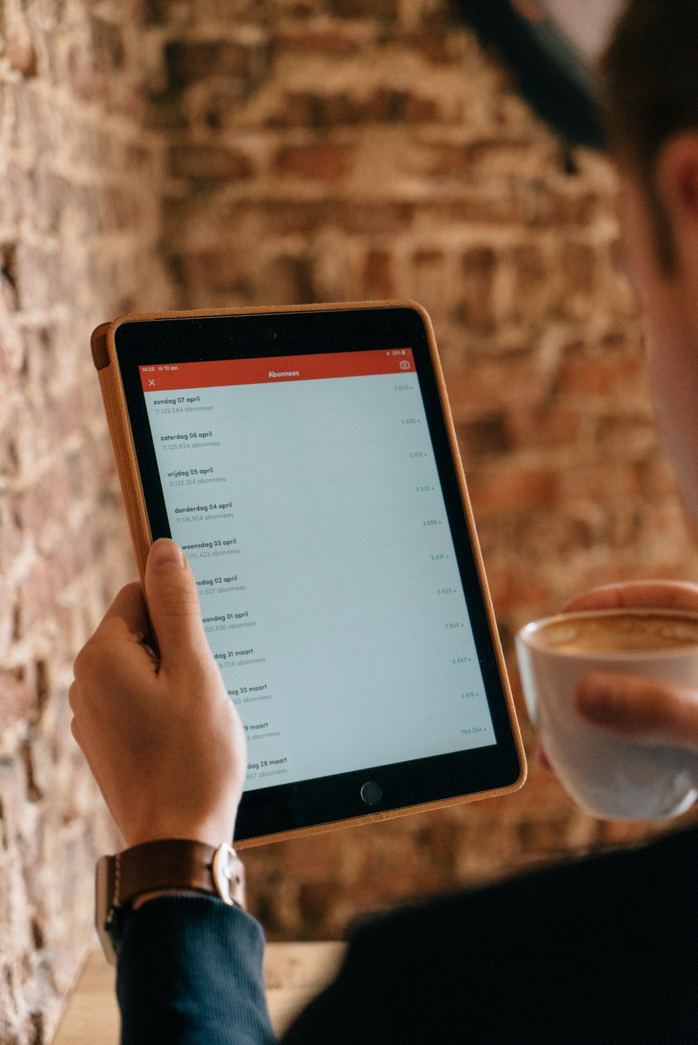 person holding black iPad