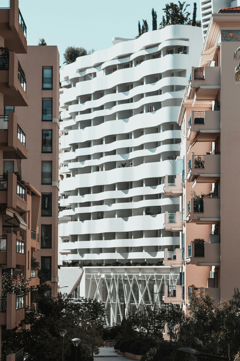 Weißes Betongebäude neben zwei braunen Gebäuden