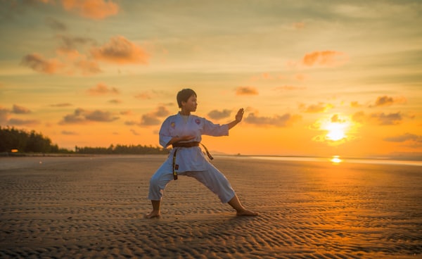 boy doing karate routines during golden hour