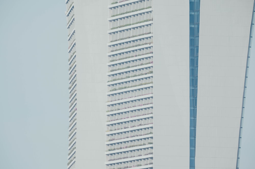 a tall white building next to a tall white building