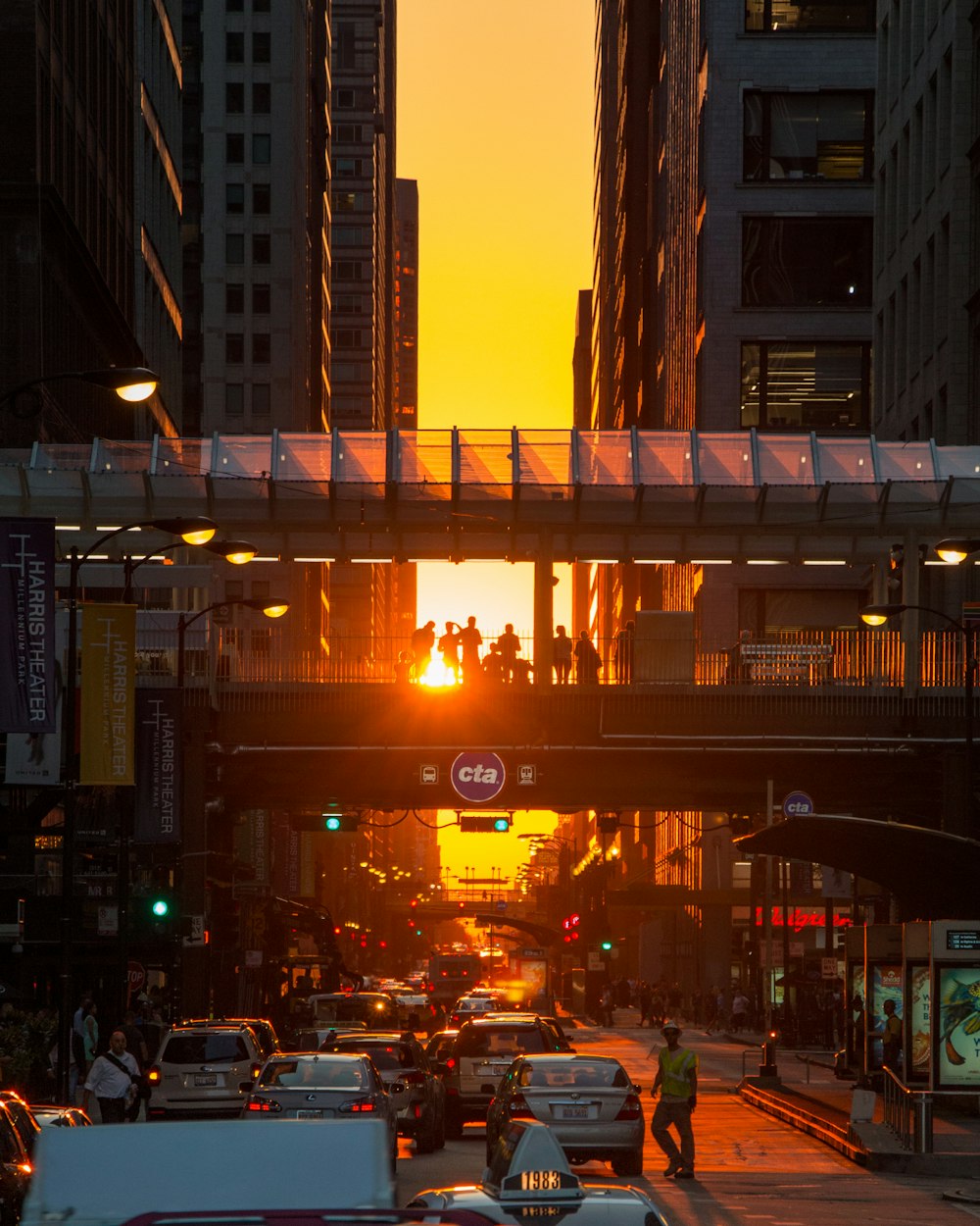 vehicles passing on road during sunset