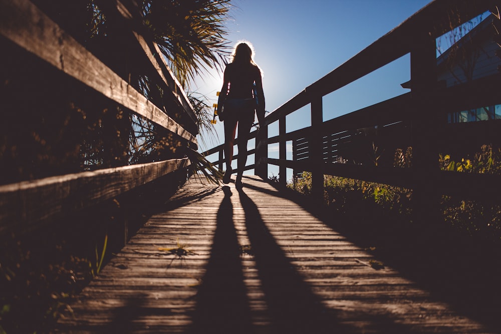 woman standing on brown bridge
