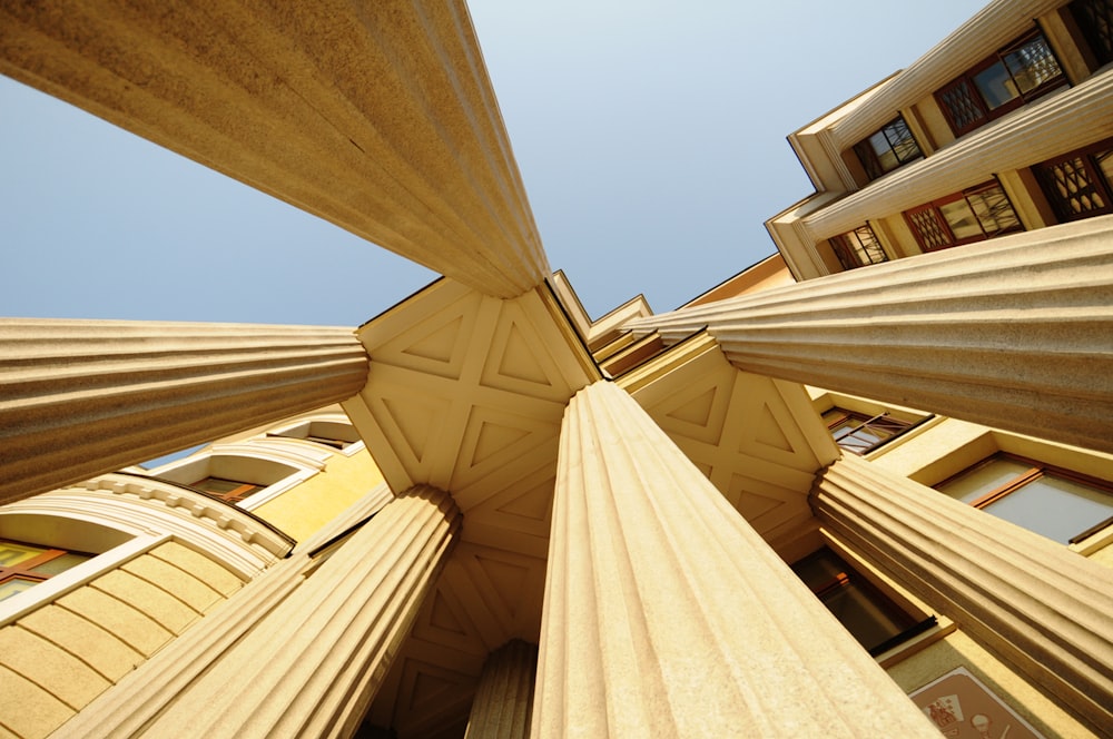 low-angle photography of concrete pillars of a building