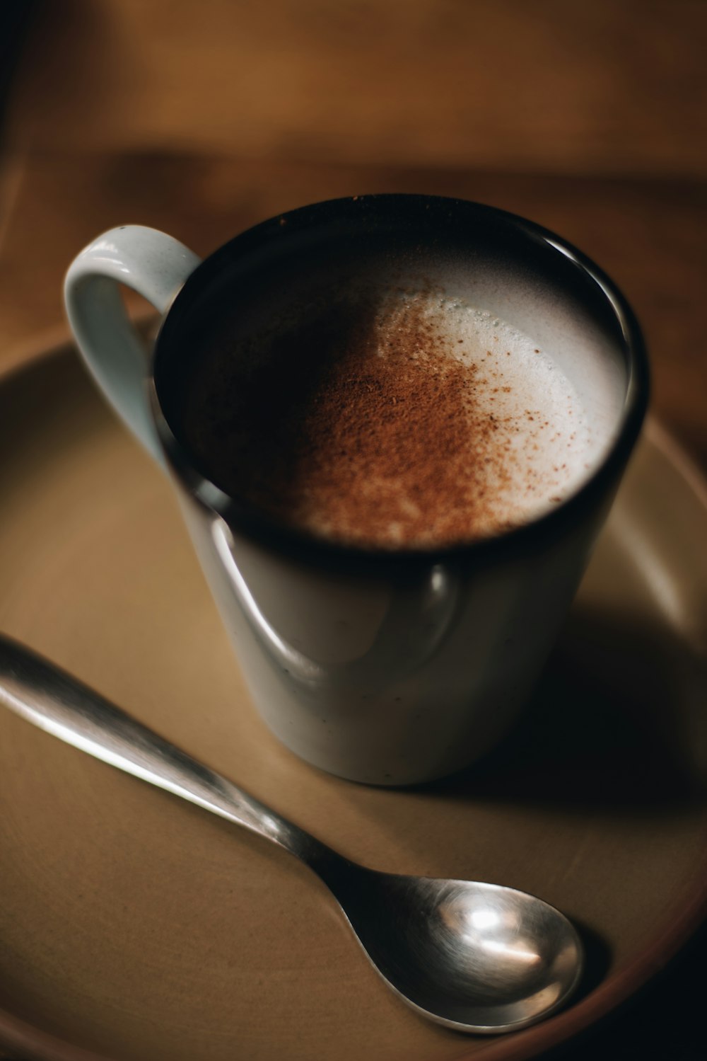 a cup of coffee with a spoon on a plate