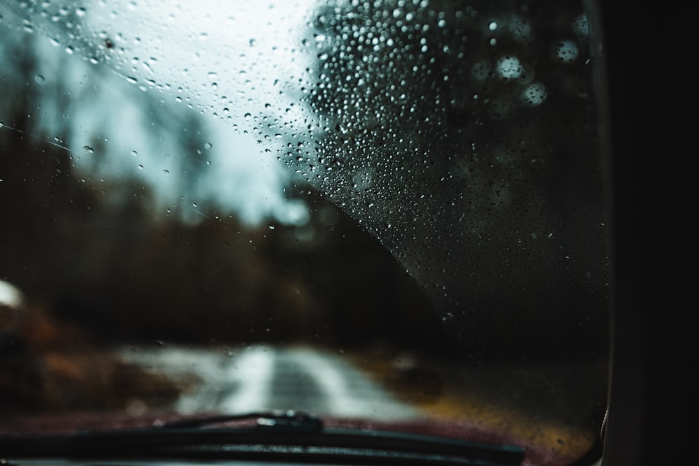 a rain covered windshield of a car on a rainy day