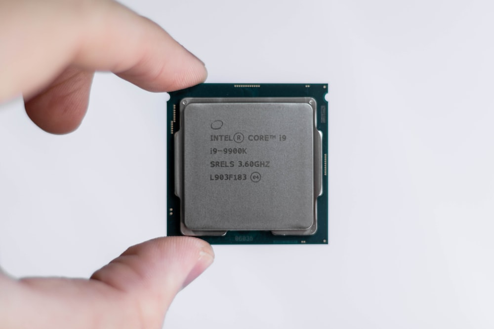 person holding Intel processor