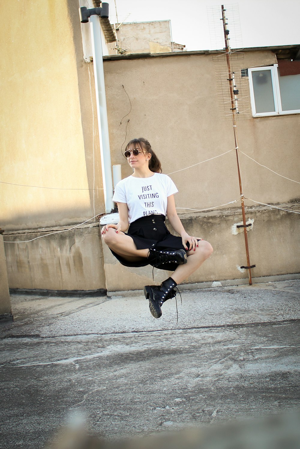 woman floating on the air near beige wall