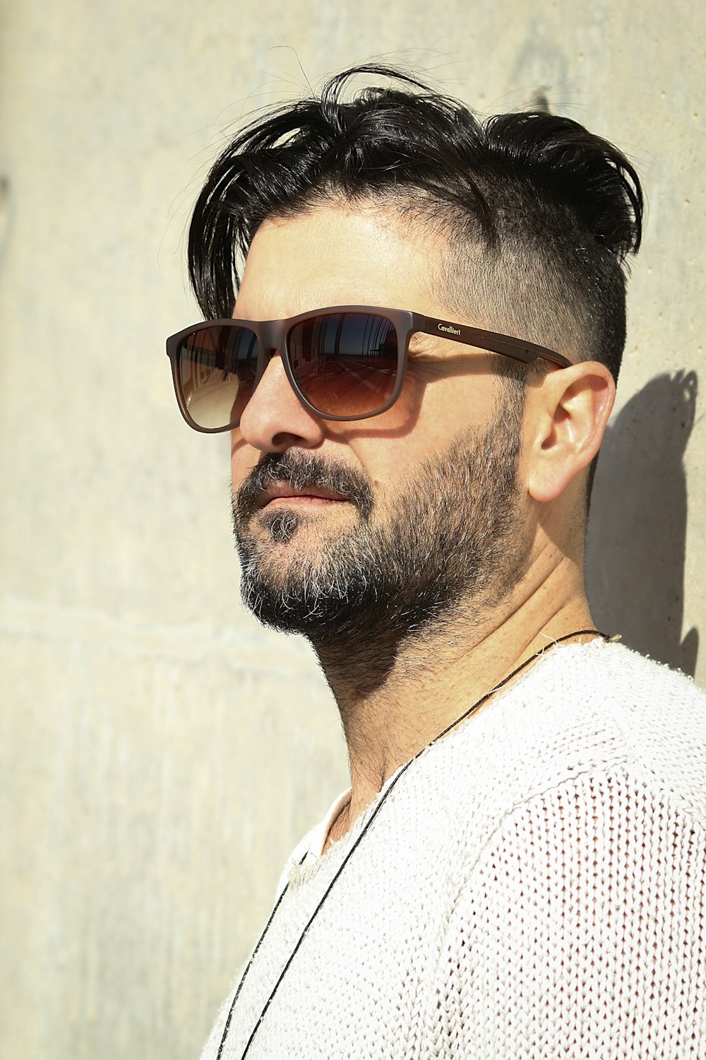 man standing while wearing brown sunglasses