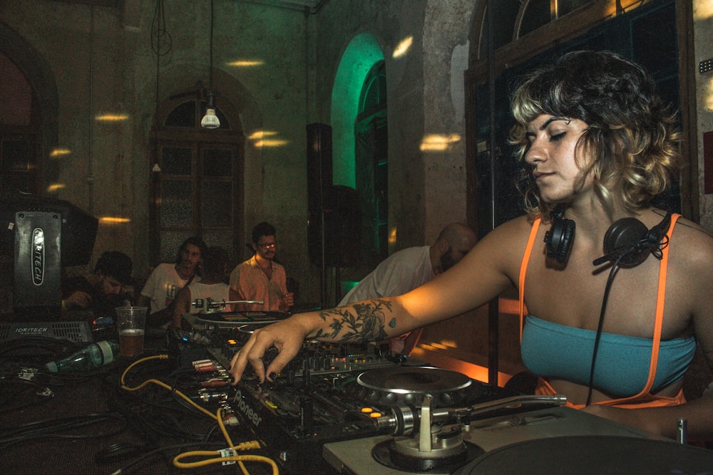 woman pkaying DJ controller at night