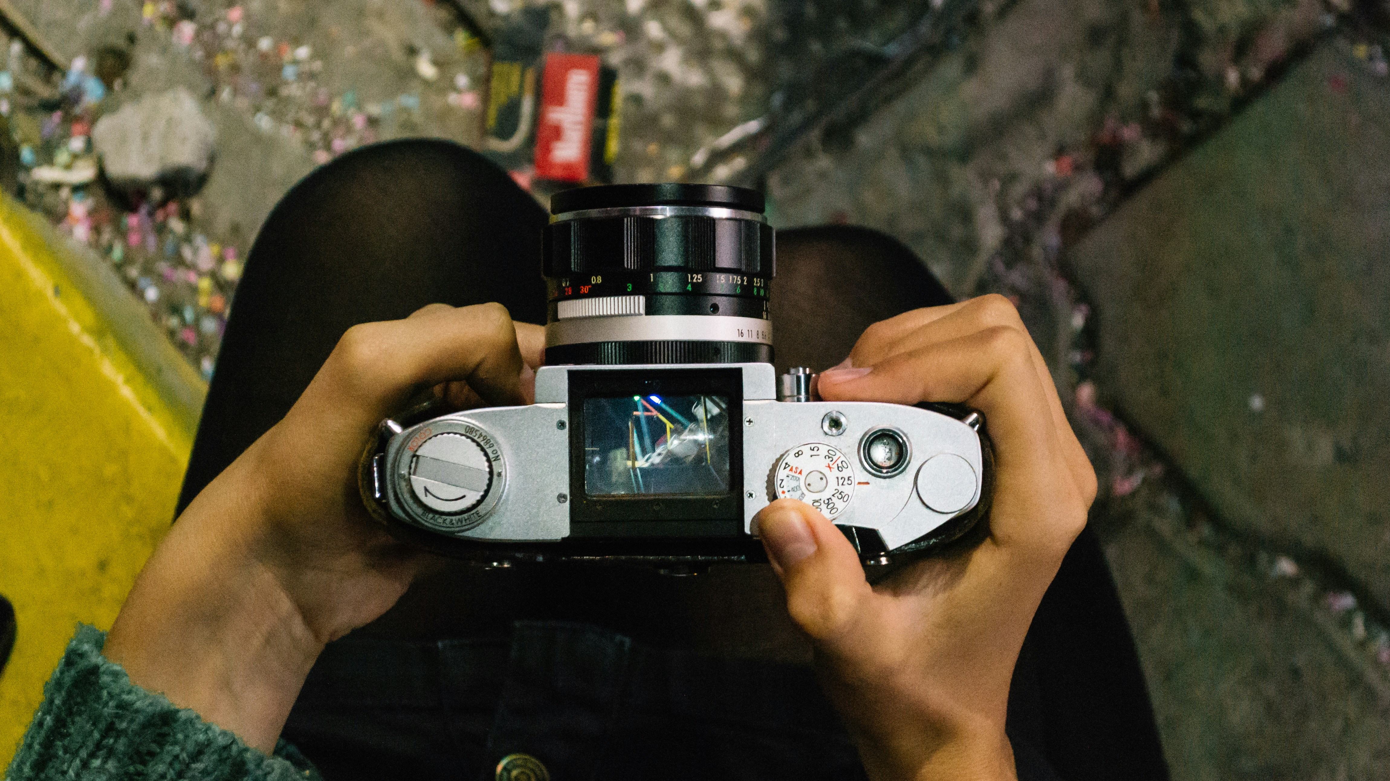 person holding gray camera