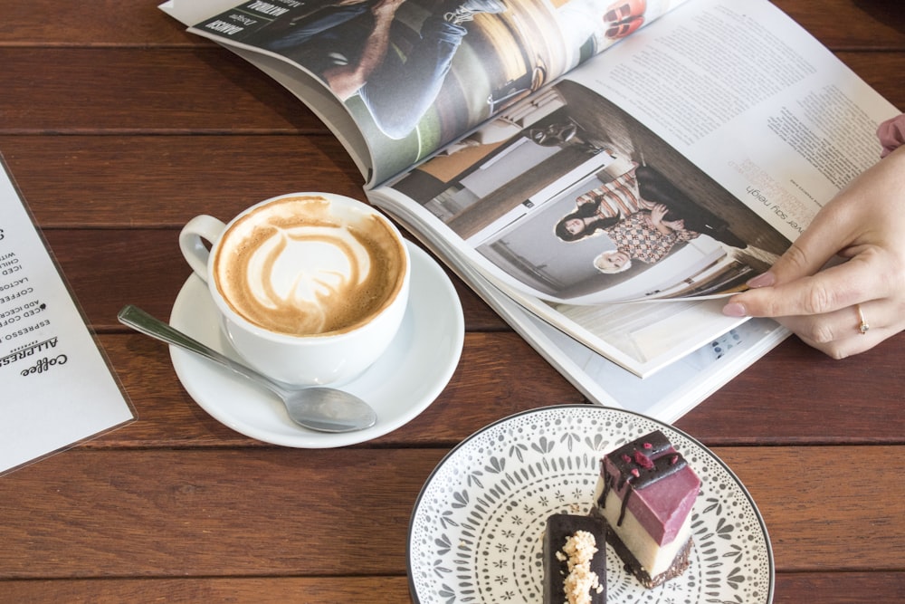 cup of latte near book