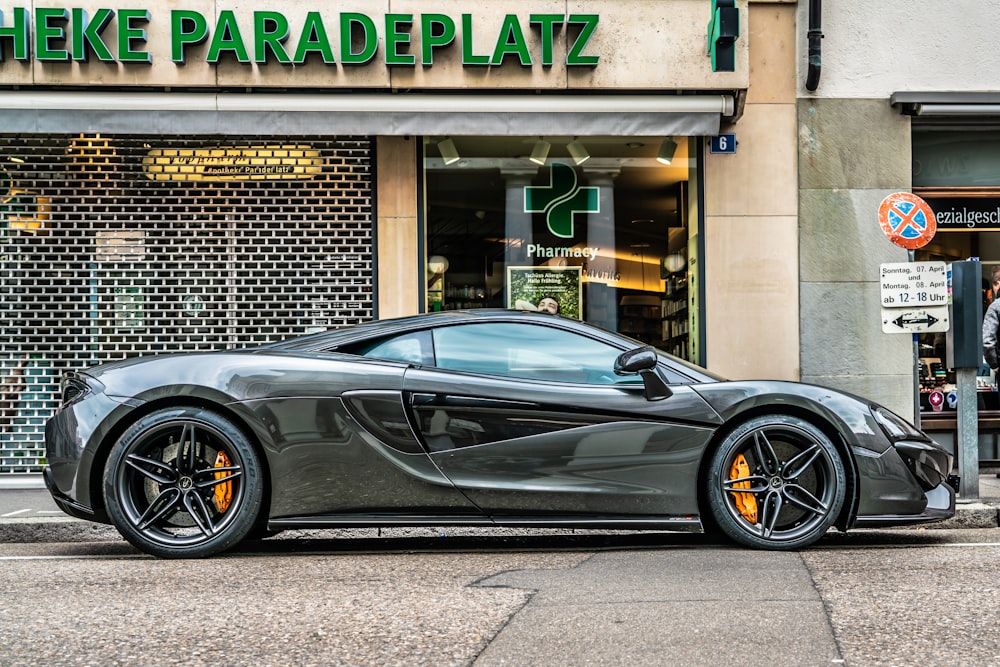 gray sports coupe parking beside store