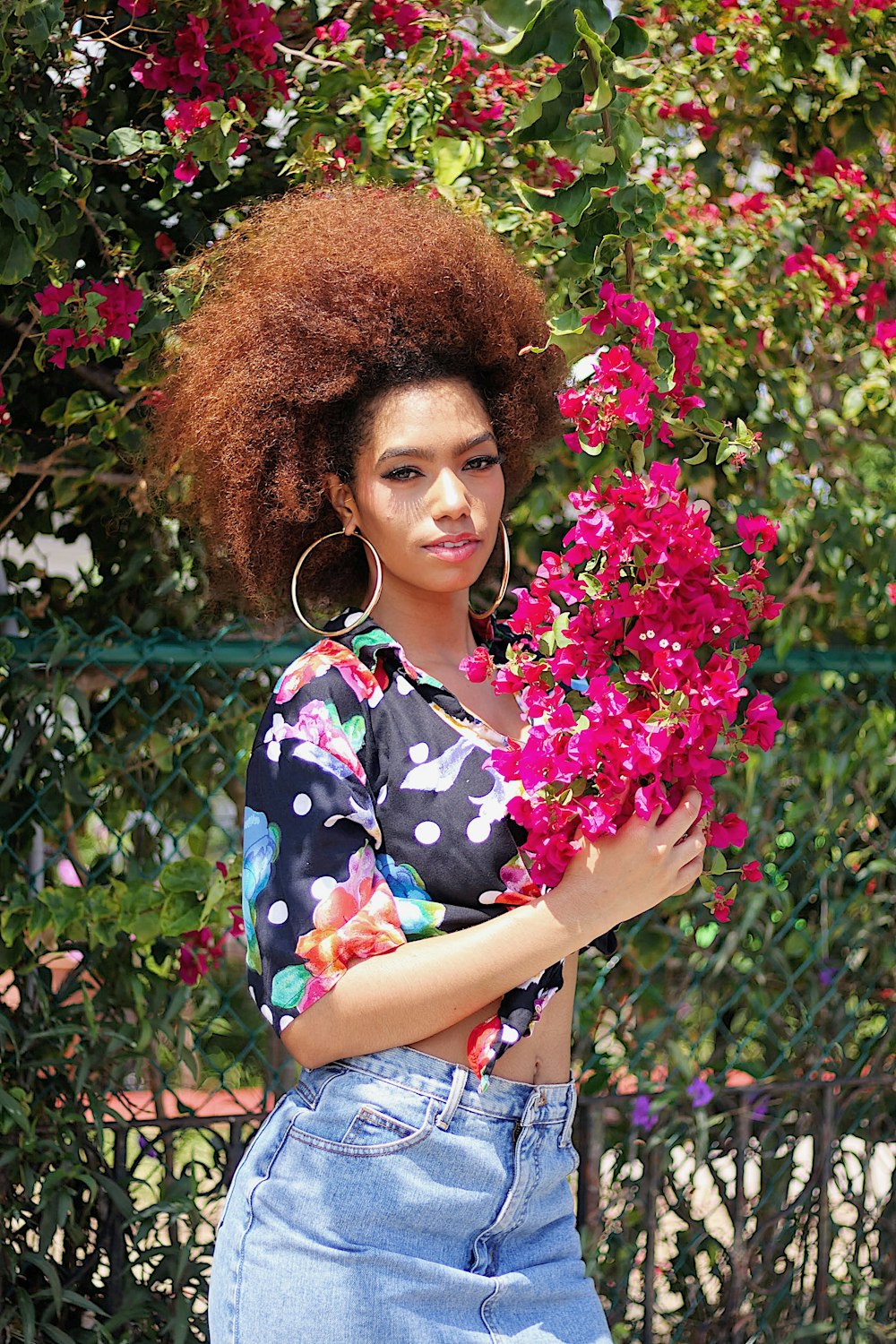 woman holding pink-petaled flower