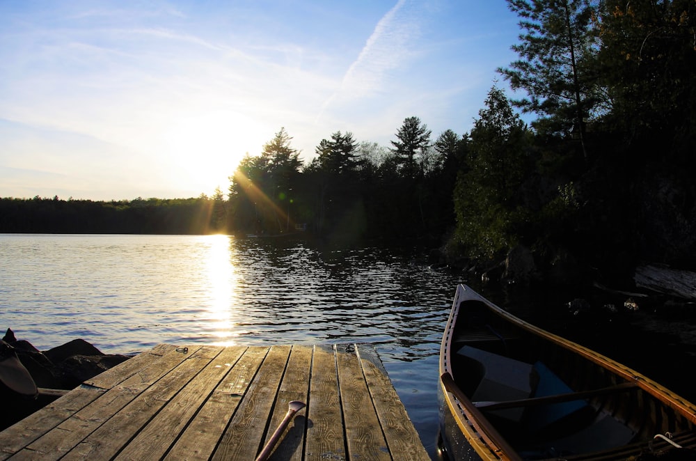 boat by wooden dock during daytime