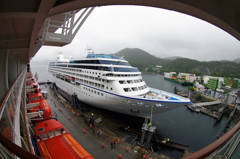 white cruise ship beside dockside