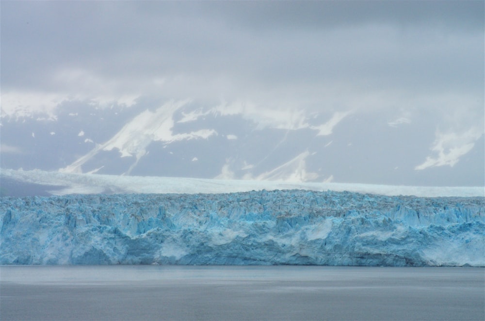 a large iceberg in the middle of a body of water