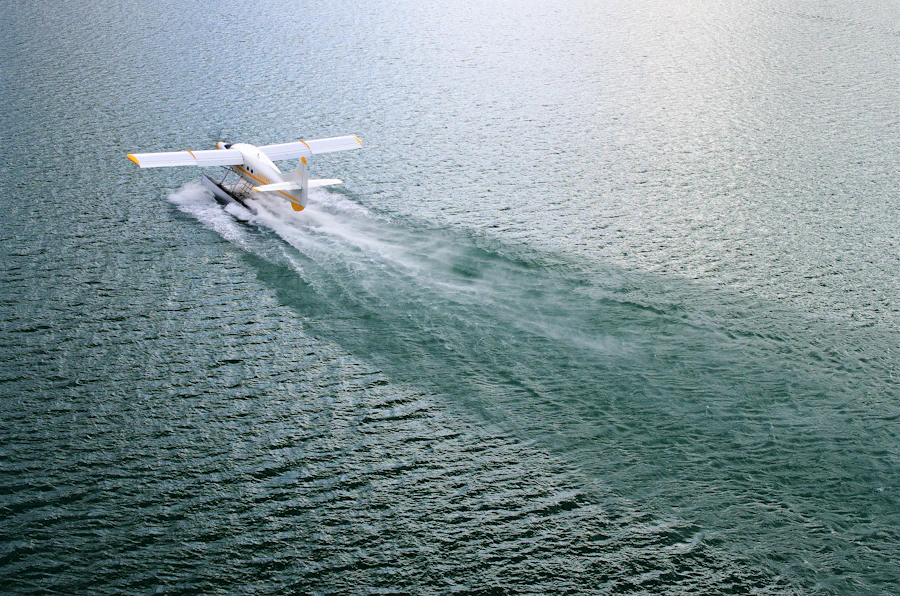 Aerial view of a seaplane moored on calm shallow water