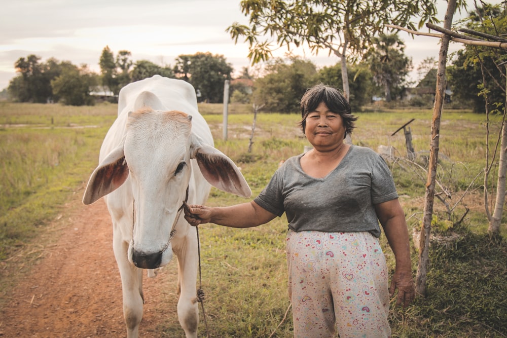 man holding rope on cow