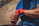 A determined fighter wrapping his hands in preparation for a match at an outdoor arena.