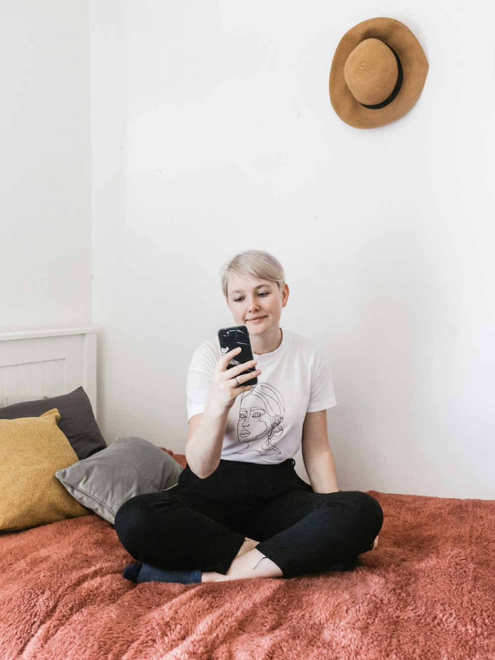 woman in crew-neck shirt by wall