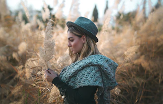 An old sepia-toned photograph of a Cherokee medicine woman holding healing herbs in a forest setting.