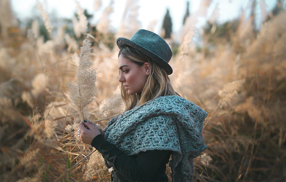 An old sepia-toned photograph of a Cherokee medicine woman holding healing herbs in a forest setting.